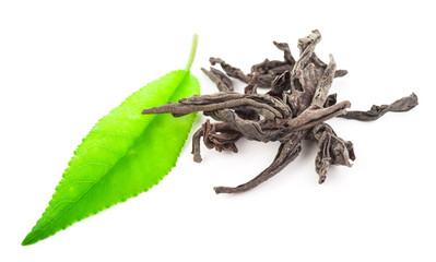 Heap of dry black tea with green tea leaves