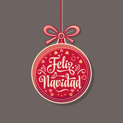 Feliz Navidad.  Red Christmas ball with good wishes in Spanish. 