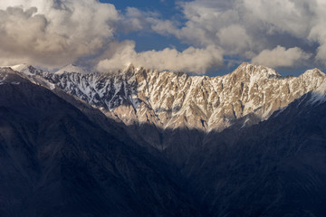 Top of moutain range and cloudy sky