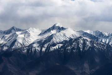 Fototapeta na wymiar Dramatic mountain range and its peak in cloudy sky, Leh Ladakh, India