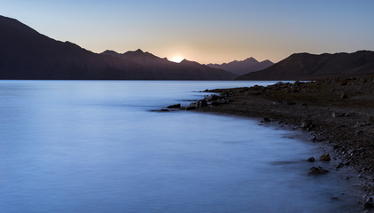 Sun rises over the mountain range at Pangong lake, Ladakh, India