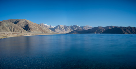 Long exposure panoramic shot of deep blue water of Pangong lake, Ladakh, India