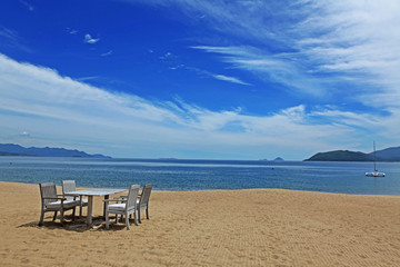 Fototapeta na wymiar Chairs and table on Nha Trang beach, Vietnam