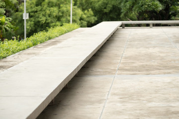 Design of seat for building exterior with garden background.