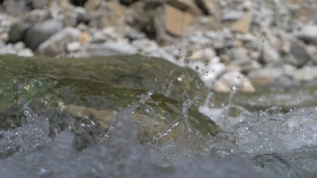 Water in a mountain river in slow motion video.