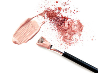 Make up beige foundation with blush and powder on white.