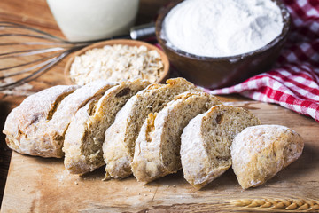 Freshly baked traditional bread on wooden table Oatmeal Bread