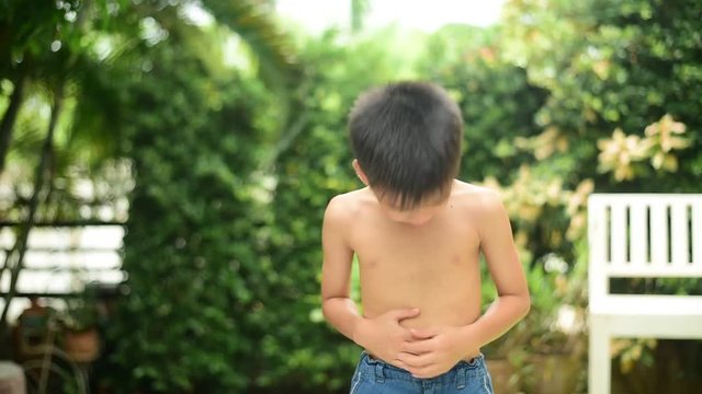 Young Asian Thai boy feel pain at his stomach