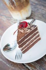 chocolate cake with cherry topping and ice coffee mocha in outdoor cafe