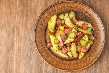 German potato salad with bacon and sausages. The view from the top. Copy-space.  