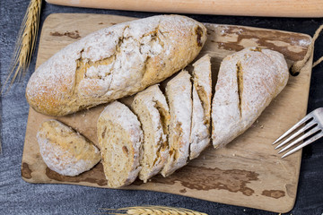 Freshly baked traditional bread on wooden table Oatmeal Bread