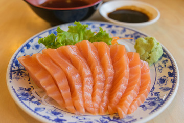 salmon fish with wasabi and sauce on table wood in restaurant