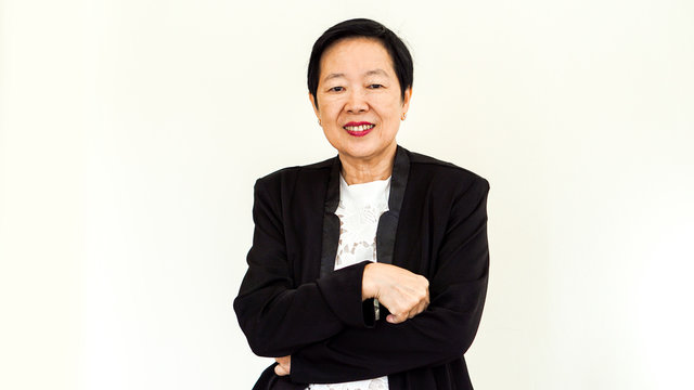 Asian senior woman wearing suit with happpy face and hand gesture on white background