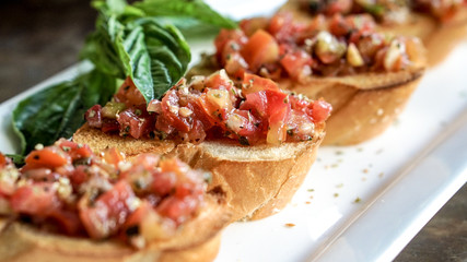 bruschetta appetizer at Italian restaurant. tomatoes refresh food