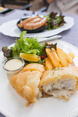 fish and chips served on a white plate