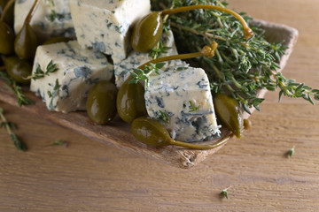 Blue cheese , capers and branches of thyme.