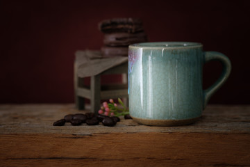 cup of coffee .on a wooden desk.