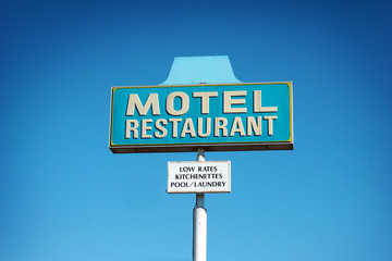 aged and worn vintage photo of motel and restaurant sign