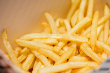 French fries serve in paper box for fast food background or texture.