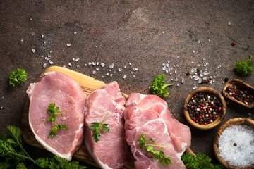 Photo sur Plexiglas Viande Fresh meat. Raw pork steak. Top view on stone table. Food background.