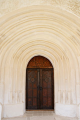 Fototapeta na wymiar Background of ancient entrance to the castle: old wooden doors with arches