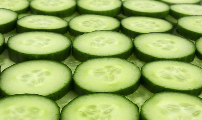 Fresh cucumber slices background.