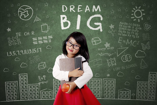 Child With Dream Big Text On Chalkboard