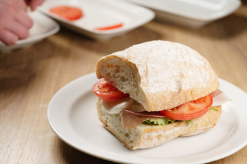 ciabatta sandwich with speck, mozzarella and vegetables