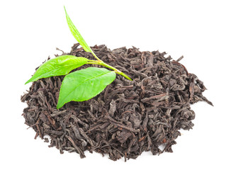 Heap of dry black tea with green tea leaves