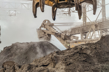 Industrial loading equipment. Hot slag in the outdoors shop of metallurgy. Heavy industrial metallurgical foggy landscape.