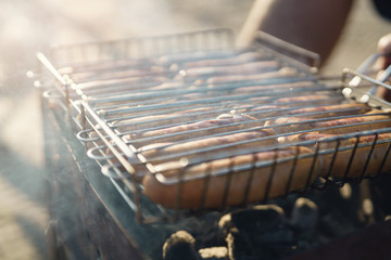 closeup shot of preparing sausages on bbq outdoors