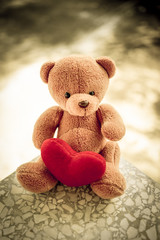 bear doll and red heart with dramatic tone, select focus the bear
