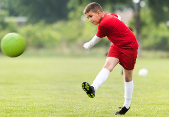 Obraz premium Kids soccer football - children players match on soccer field