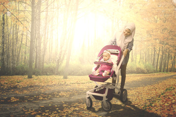 Muslim woman with her baby in the park