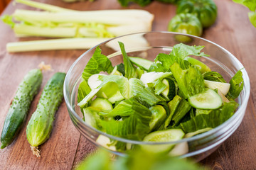 vegetable green salad bowl on kitchen table, balanced diet