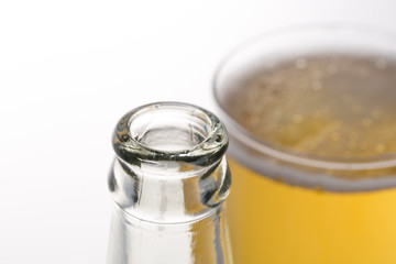 Glass of beer with bottle isolated on white. Closeup.