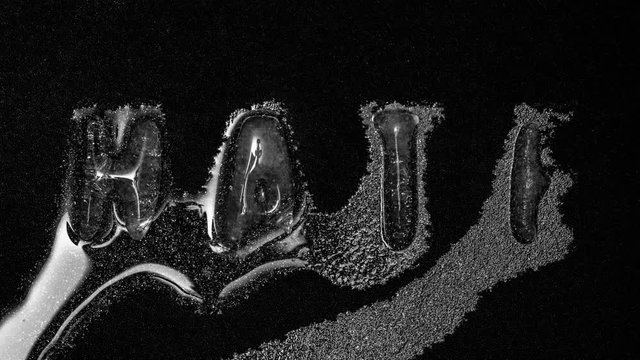The word Hate is formed from water into ice letters, melting reverse, 4k footage, Timelapse