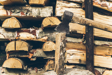 axe in log on a firewood background