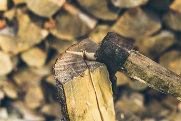 axe in log on a firewood background