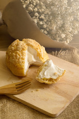 Choux Cream on plate. Cream puffs filled vanilla and milk custard