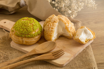 Choux Cream on plate. Cream puffs filled vanilla and milk custard