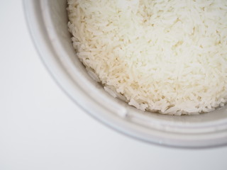 Thai local traditional boiled white jasmine rice in aluminum cooker pot, top view, corner