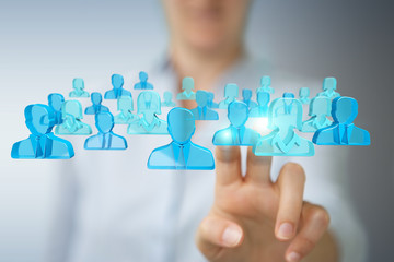 Businesswoman holding and touching 3D rendering group of blue people