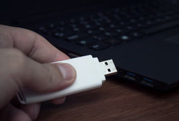 Hand holding USB Flash drive.