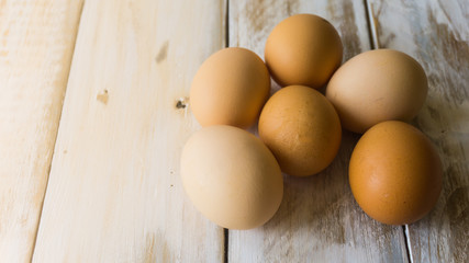 Close up of fresh chicken egg on nature wooden table