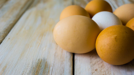 Close up of fresh chicken egg on nature wooden table