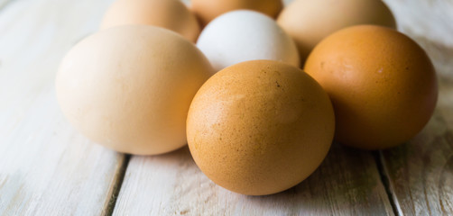 Close up of fresh chicken egg on nature wooden table