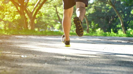 Runner feet running on road.