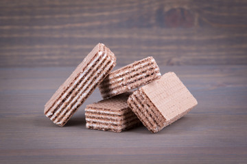 Waffles with sweet filling on a wooden background.