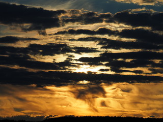 Fototapeta premium Layers of clouds against sunset